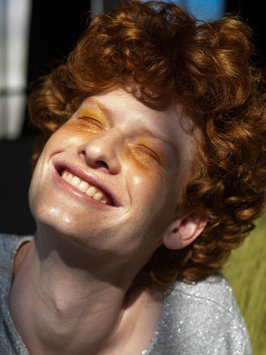 Portrait of a man with red hair smiling on the sun