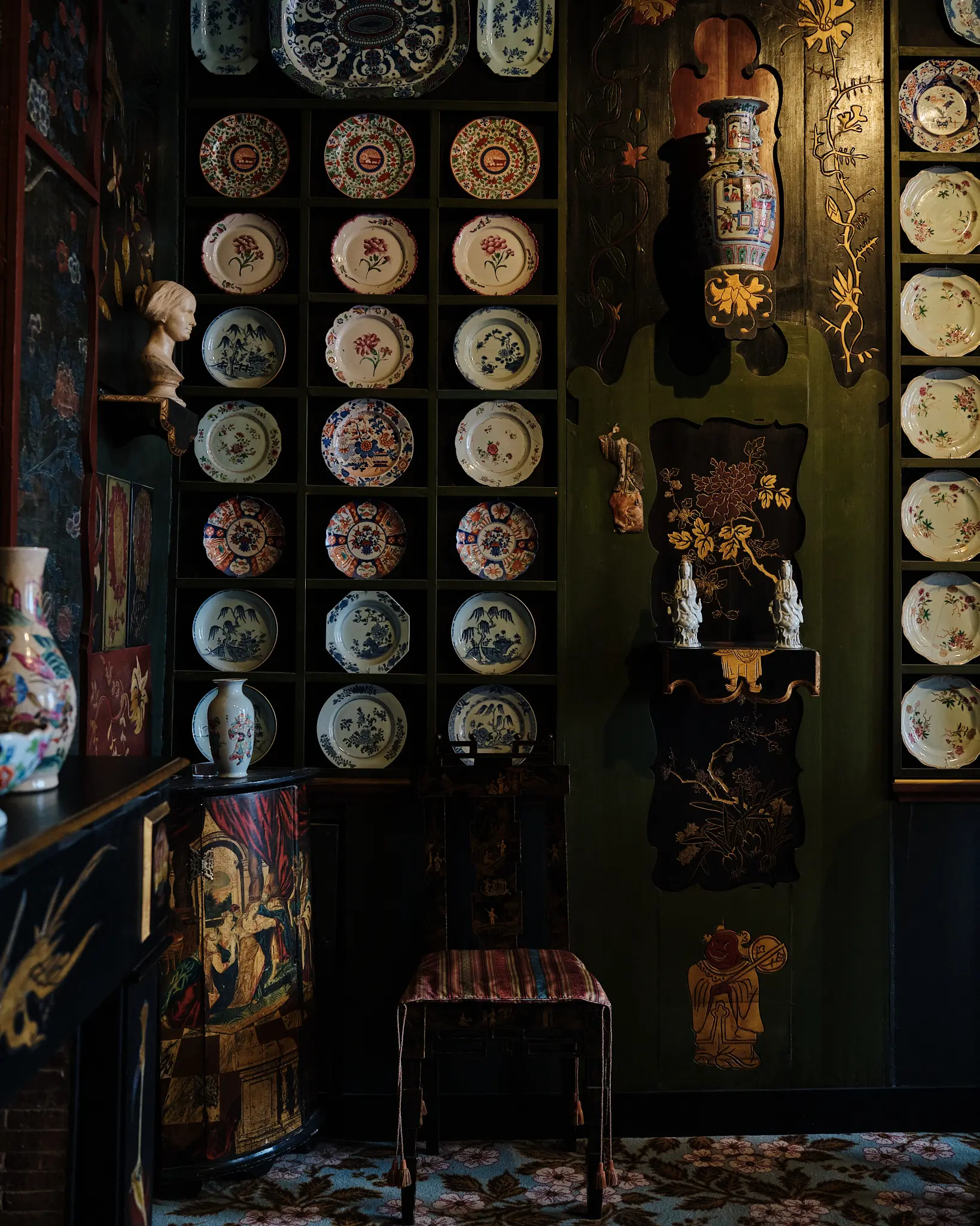 Ceramic Display Wall — Maison de Victor Hugo Decorative interior with wall-mounted ceramic plates, painted wooden panels, and curated objects inside Maison de Victor Hugo, Paris.